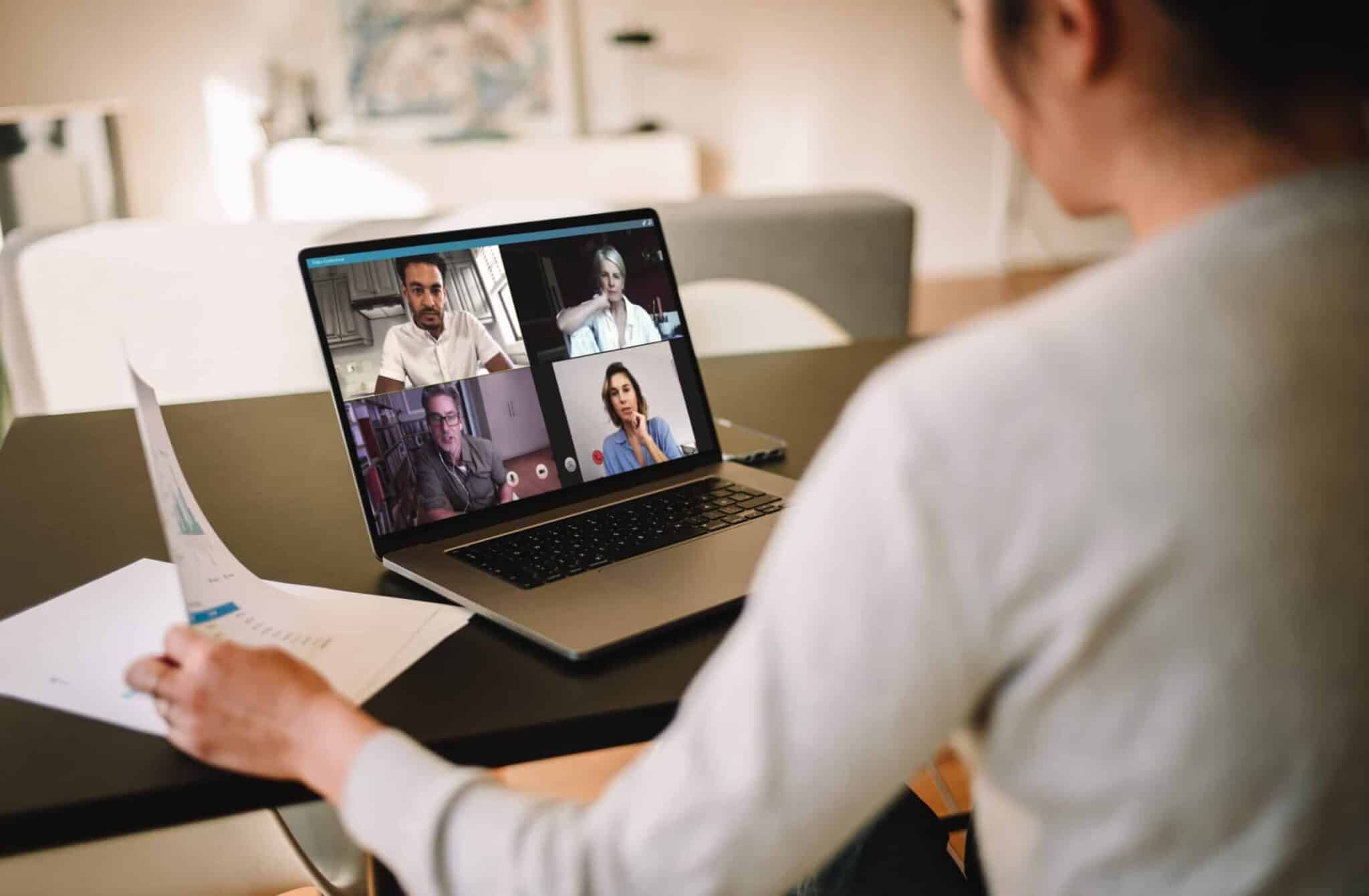 businesswoman at home having a video conference with her team